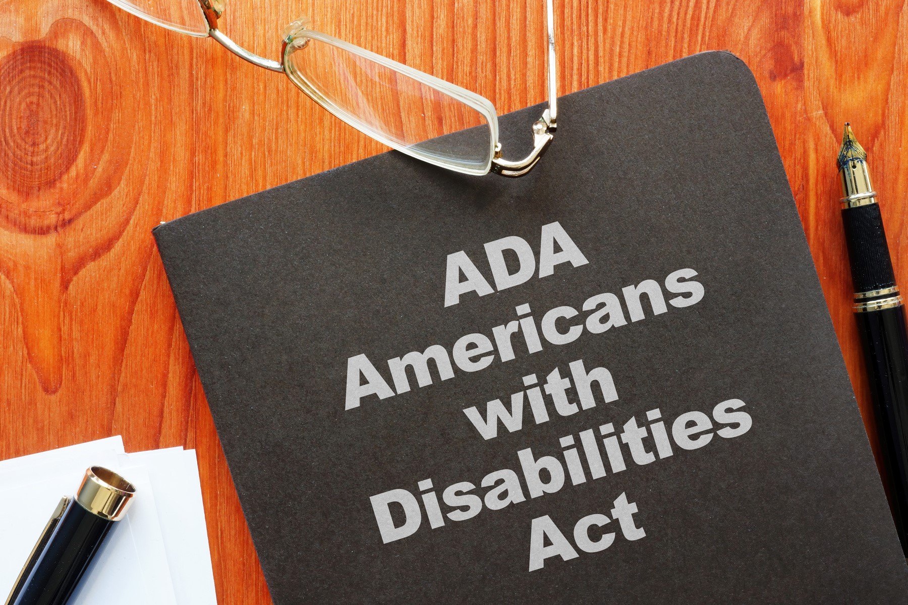 Illustration of an ADA document and accessibility icon