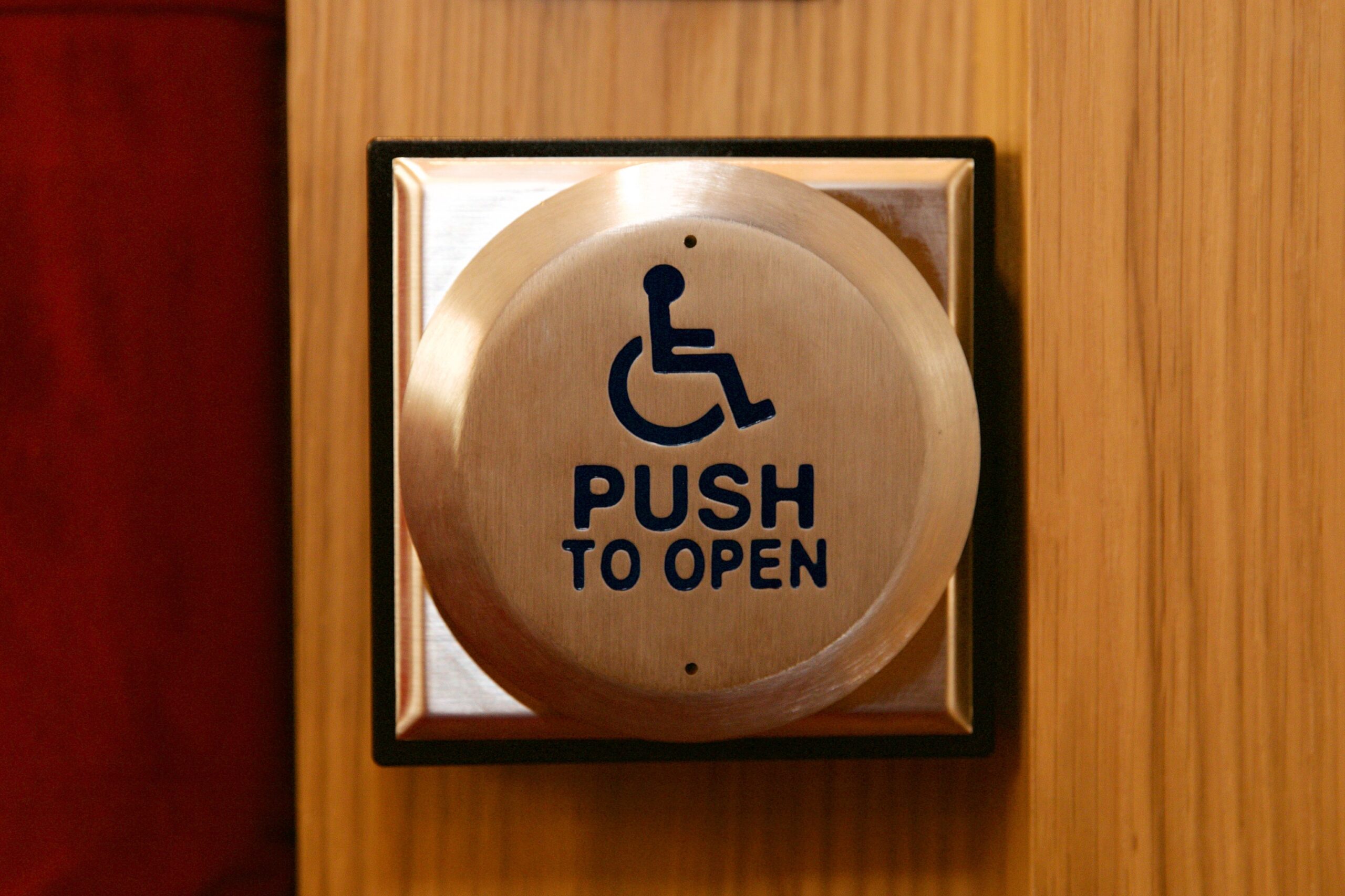 Automatic door operator with ADA accessibility signage