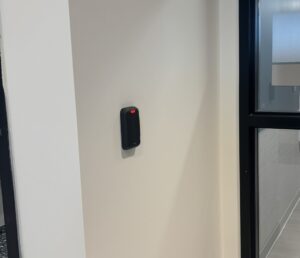 Property manager demonstrating keyless access on a smartphone near an entry